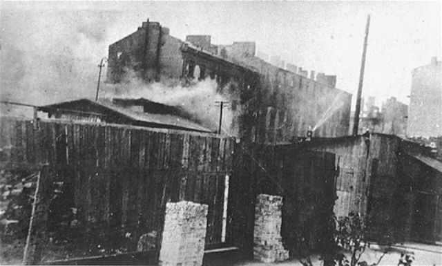 Apartment buildings burn during the suppression of the Warsaw ghetto uprising